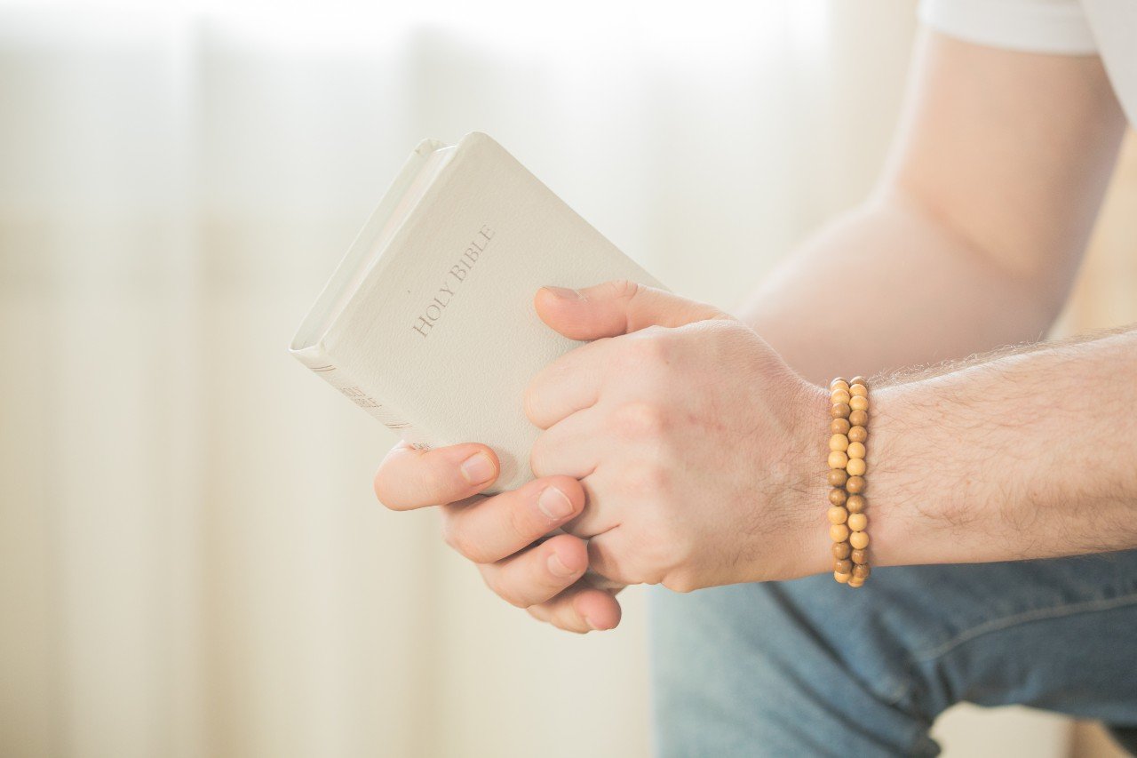 the-christian-holds-the-bible-in-his-hands-readin the-christian-holds-the-bible-in-his-hands-readin